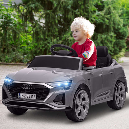 Gray kids 12V ride-on car with open-top seats and LED headlights, front grille
