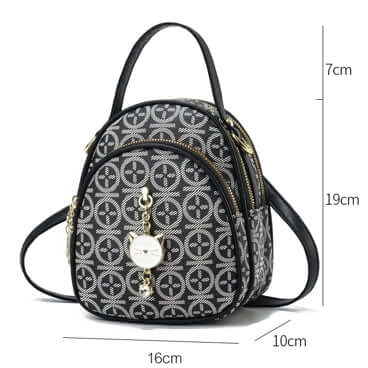 Black patterned crossbody handbag with top handle, short strap, and heart charm