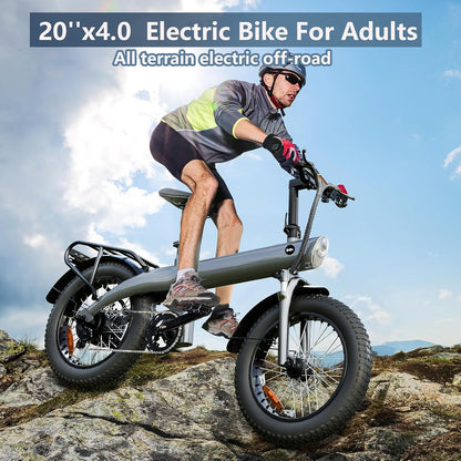 Grey electric dirt bike for adults with 20 in fat tires, standing on rocky ground