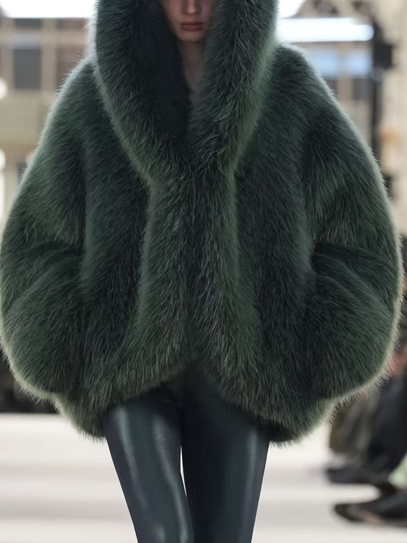 Dark green faux fur hooded coat with wide hood and open front.