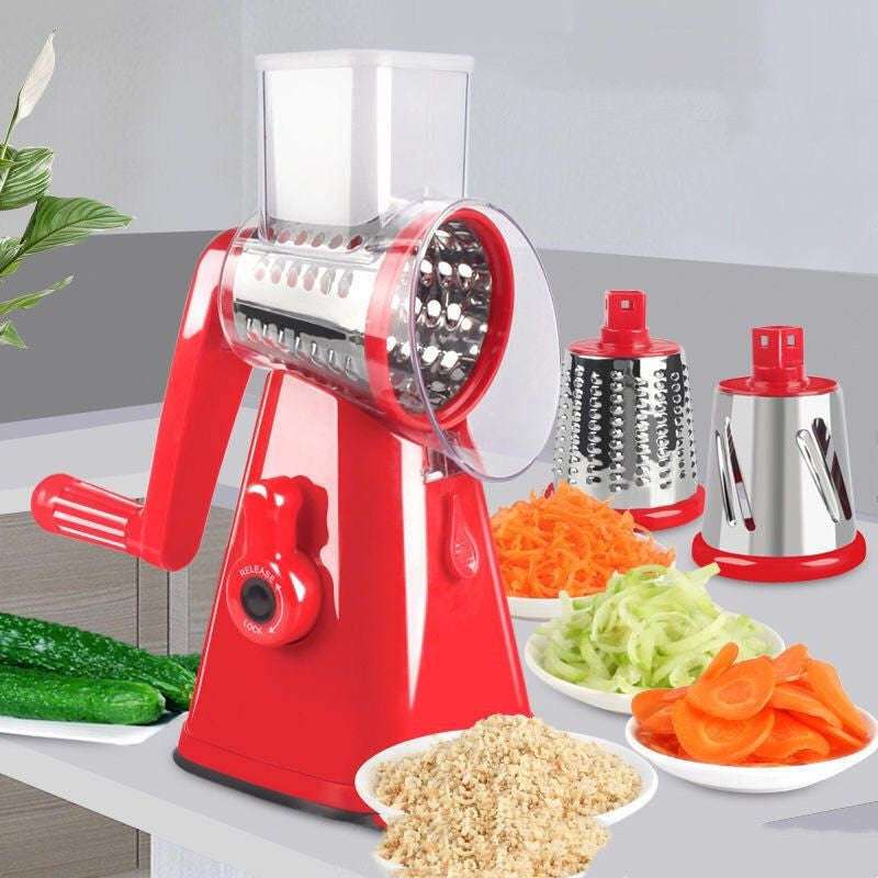 A red hand drum vegetable cutter slicer with stainless steel drums, shown alongside sliced vegetables.