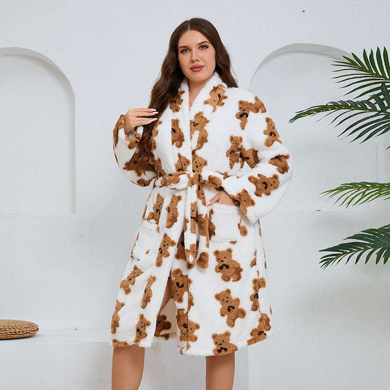 Woman wearing a white robe with brown teddy bear patterns against a white background
