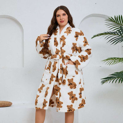 Woman wearing a white robe with brown teddy bear patterns against a white background