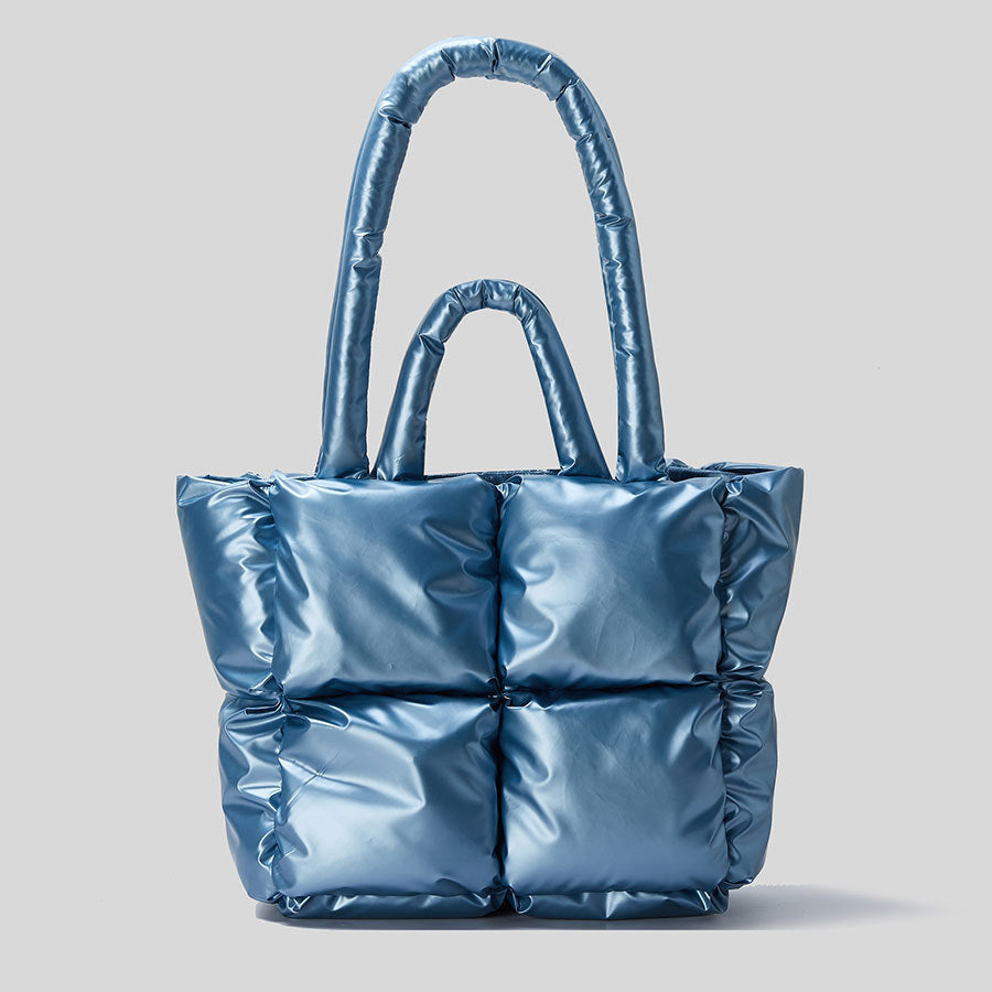 Light blue puffer tote handbag with two top handles and quilted front panels