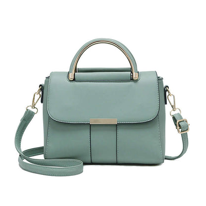 Mint green small crossbody bag with structured flap, top handle, and side straps