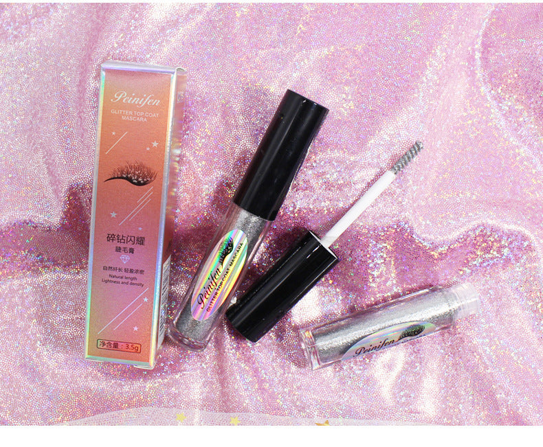 Eyelash extensions and applicator on a glittery pink background