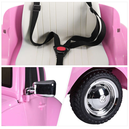 Pink ride-on car seatbelt and wheel detail with black tire and chrome hub