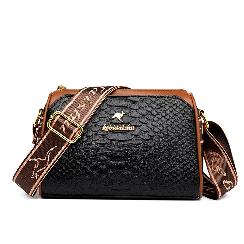 Rhombus leather shoulder messenger bag with textured black body, tan trim, and patterned strap