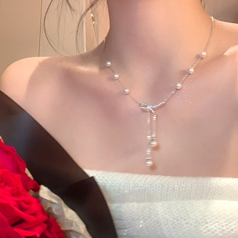 Butterfly pearl necklace with pearl beads and dangling charm strand
