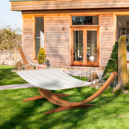 Outdoor hammock bed with white hammock and arched wooden stand