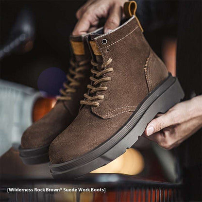 Brown suede work boots being held with a blurred background