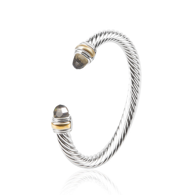 Twisted wire bohemian bracelet with faceted gray bead and gold-toned accents