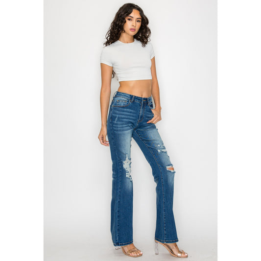 Close-up of women's slim-fit skinny jeans in a medium wash, featuring a high-rise waist and a clean ankle-length hem.