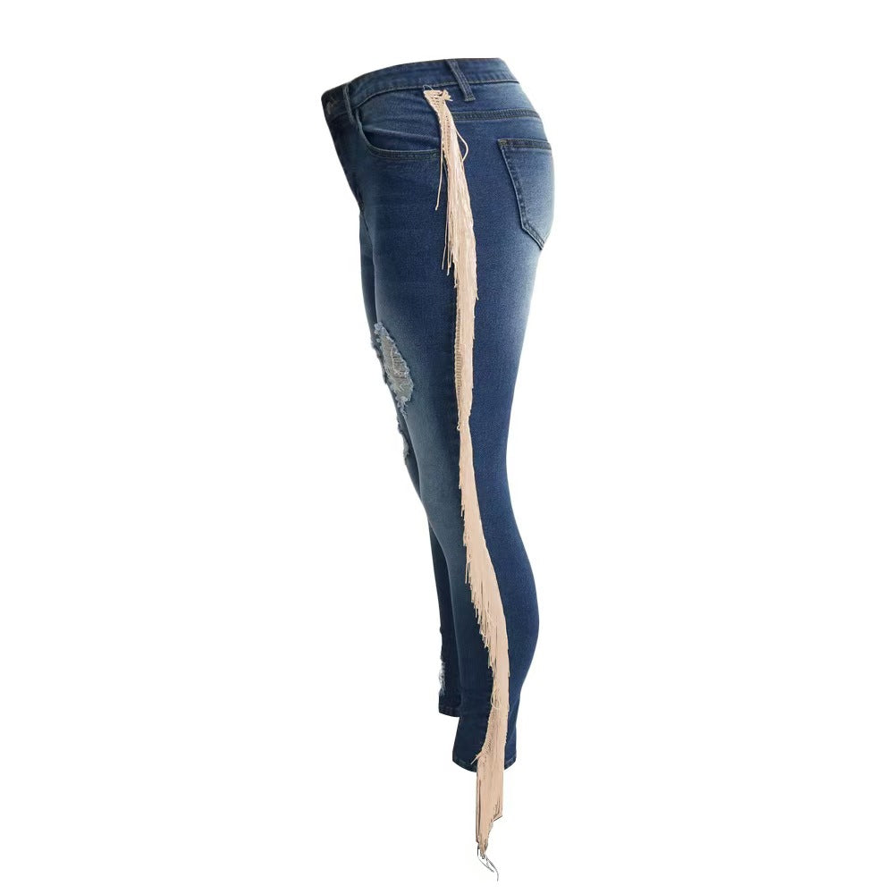 Blue skinny jeans with ripped side seams and long tassel fringe