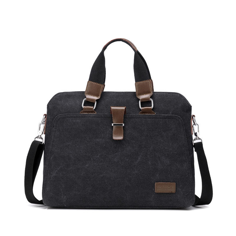 Canvas briefcase in black with dual top handles, front clasp panel, and adjustable shoulder strap