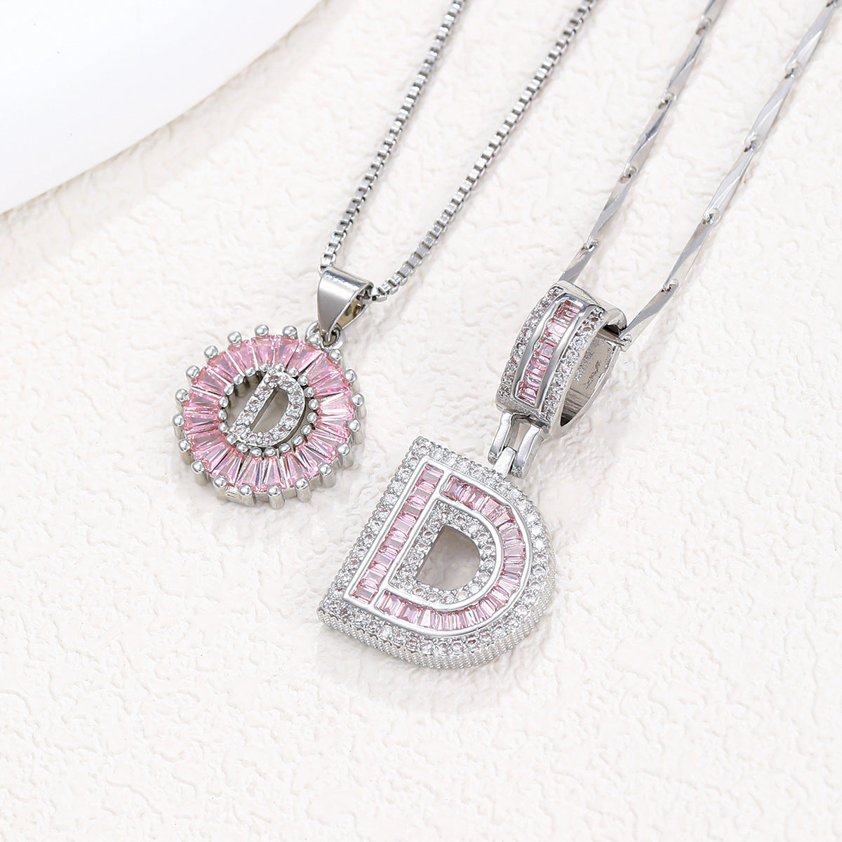Silver-tone pendant necklace set featuring pink crystal flower halo pendant and letter charm