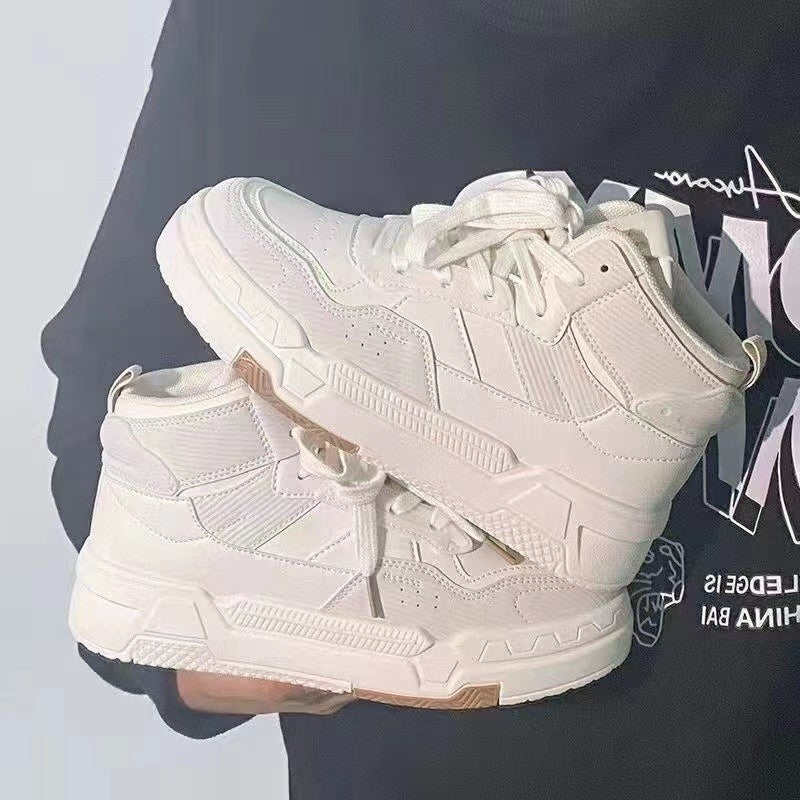 White lace-up platform sneakers, thick ridged midsole and outsole on display.