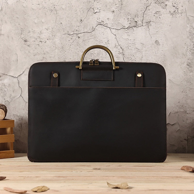 Dark leather business & laptop bag with top handle, two front pockets, metal rivets