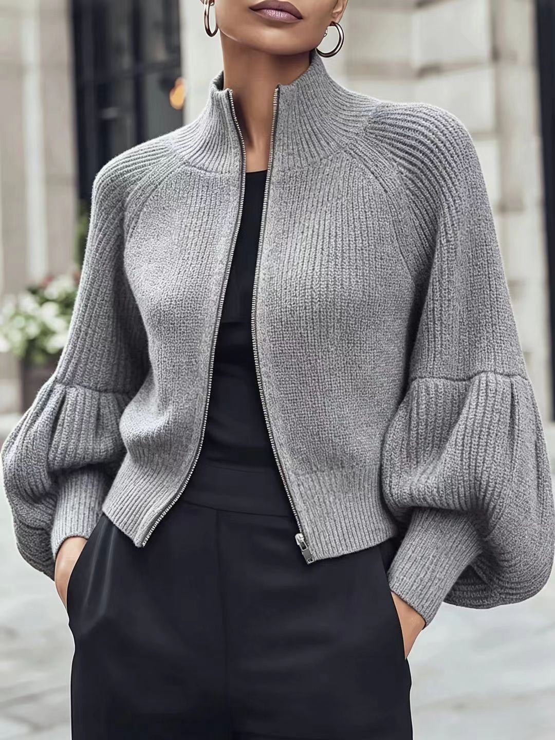 Light grey textured knit zip-front sweater with lantern sleeves and ribbed turtleneck collar
