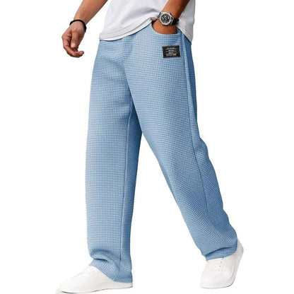 Light blue checkered pants worn by a person on a white background