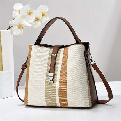 Large crossbody handbag in cream and tan vertical stripes with brown top handles