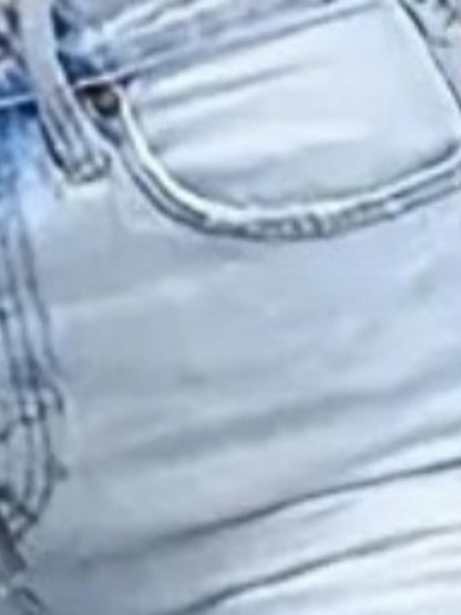 Light wash denim jeans close-up of waistband stitching and front seam