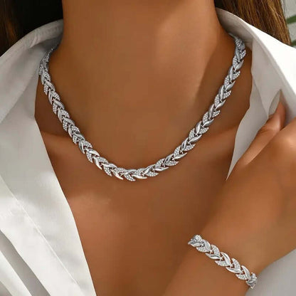 Rhinestone leaf necklace and bracelet set in silver tone, on model neckline and wrist.
