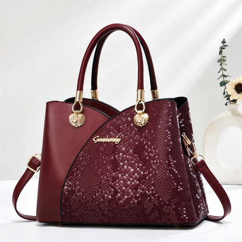 Date red stone-pattern tote bag with red handles, gold hardware, and side strap