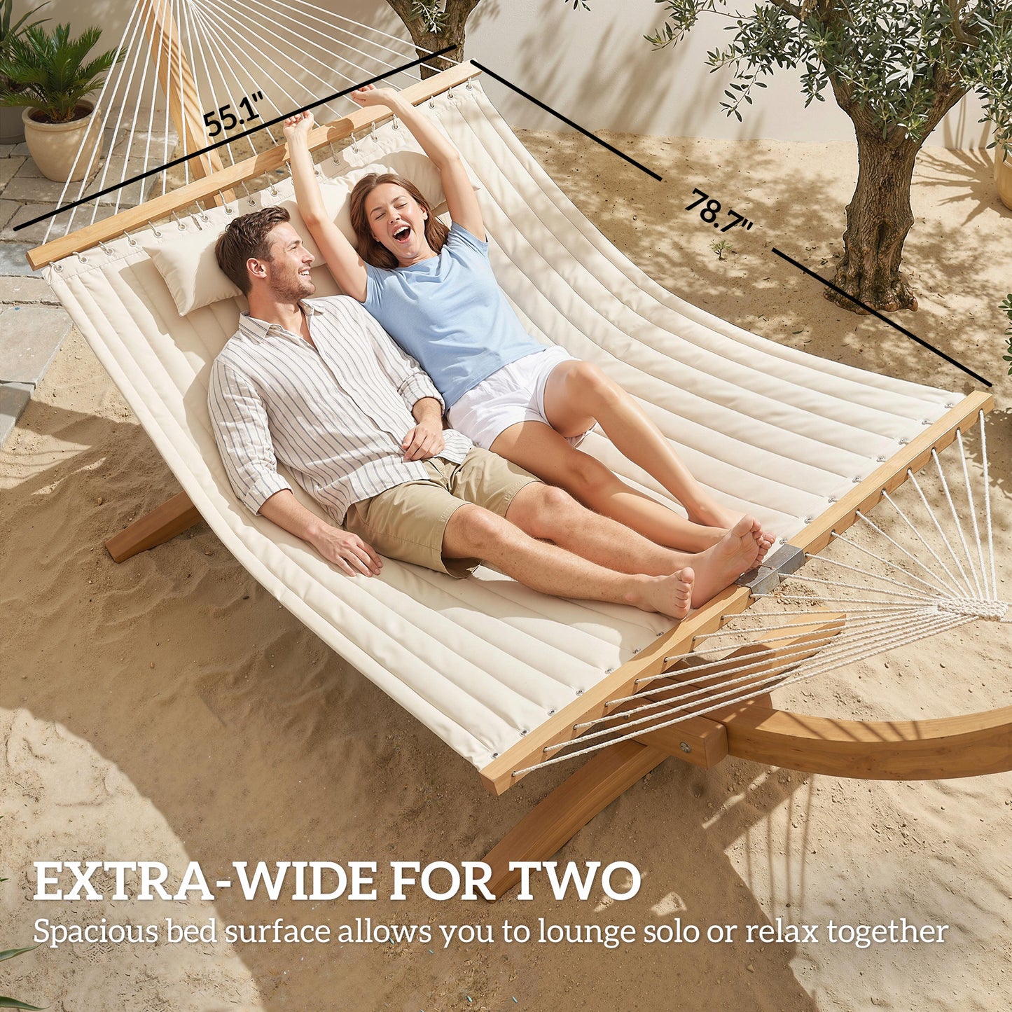 Extra-wide cream two-person hammock with attached pillow, two people reclining