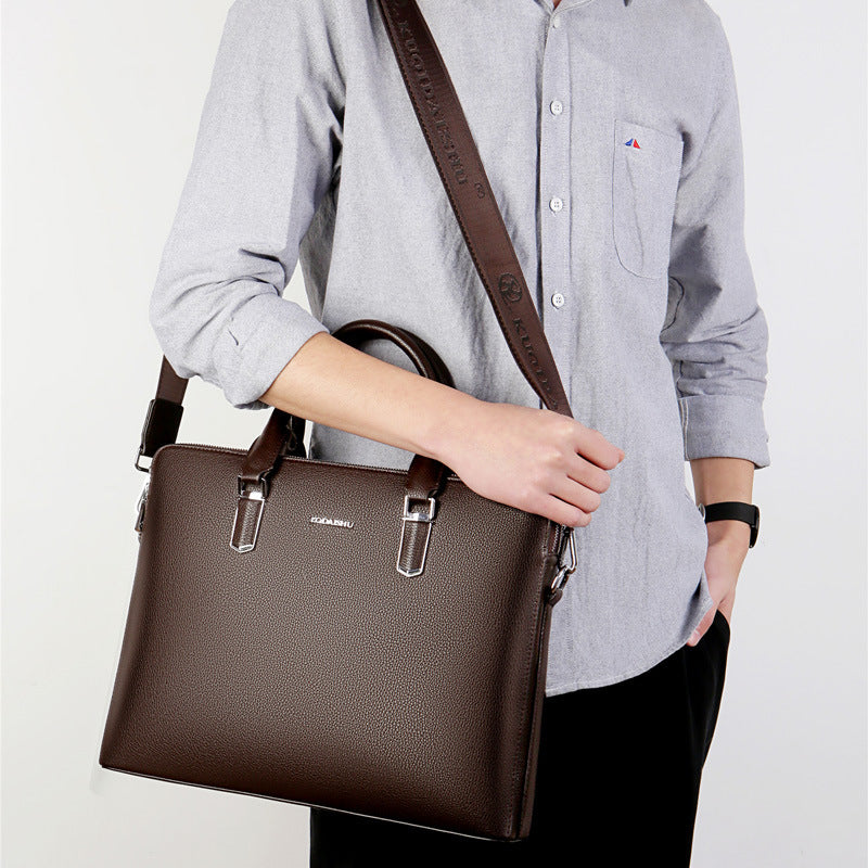 Men's brown leather computer bag with shoulder strap and two top handle buckles