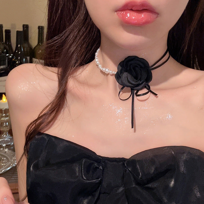 Pearl choker necklace with black flower bow ribbon and dangling charm