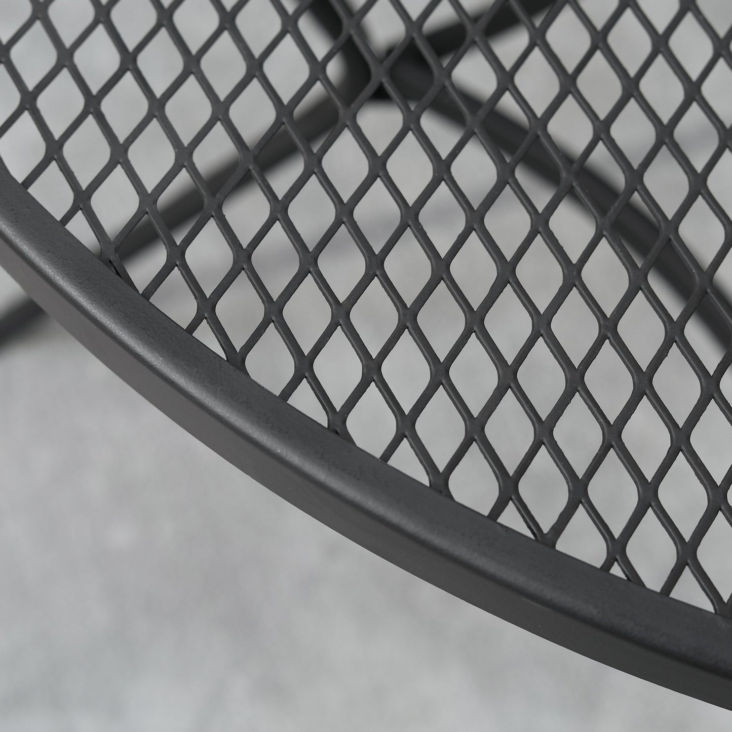 Black metal wire mesh detail on tabletop edge and curved support bar