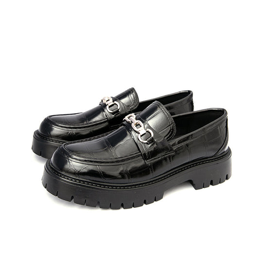 Black glossy loafers with chain details on a white background