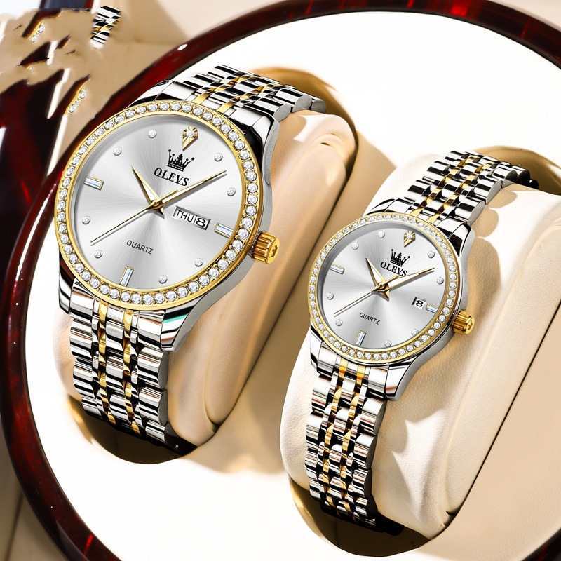 Pair of white-faced diamond bezel watches with silver metal link bands on display