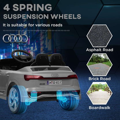 Gray kids ride-on car with rear light bar and four spinning suspension wheels