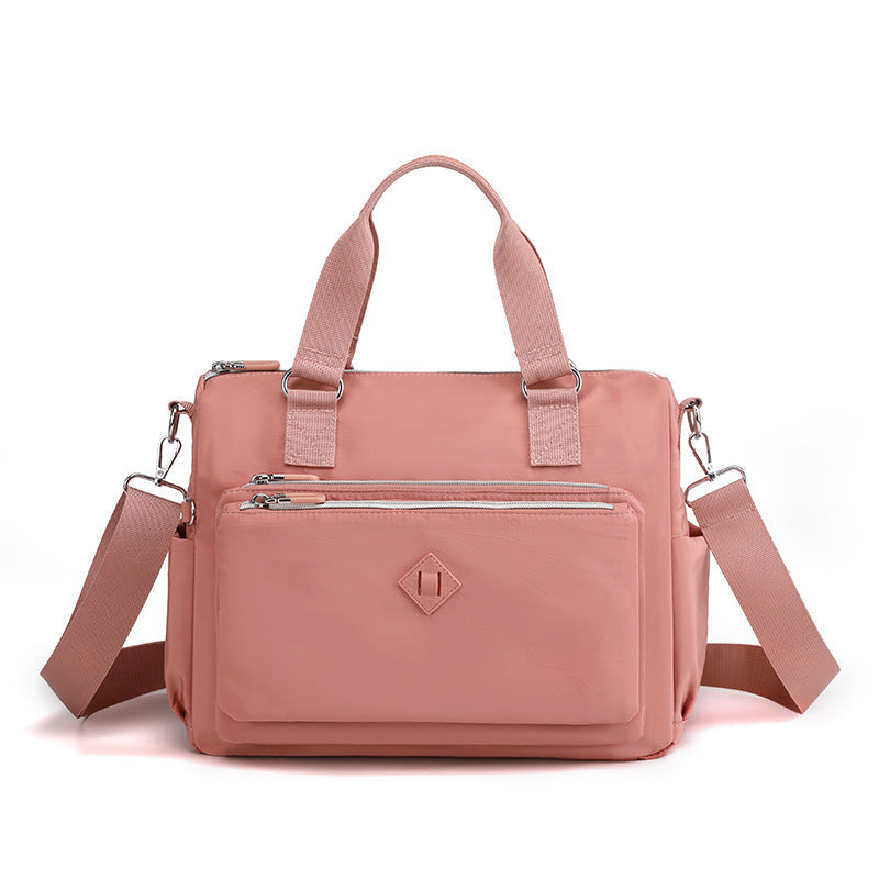 Waterproof nylon one-shoulder bag, pink, front view with zip pocket and shoulder strap