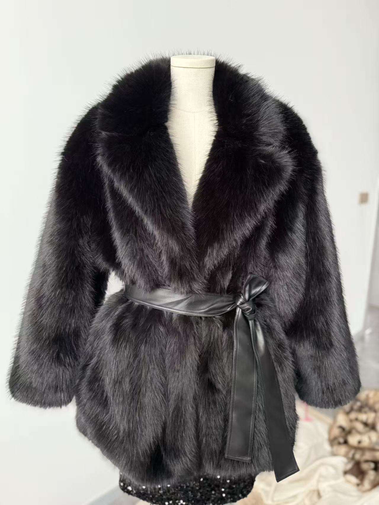 Mid-length faux wool coat in black on mannequin with shawl collar and waist tie belt