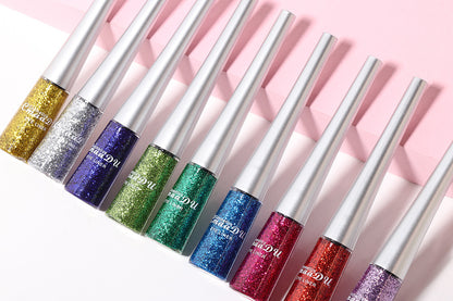 Set of colorful lip glosses with glittery finish on a pink background