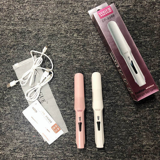 Two hair straighteners, one pink and one white, with their packaging and accessories on a textured surface.