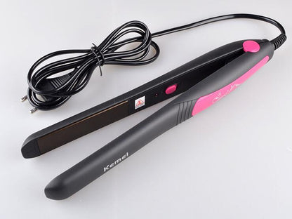 Black and pink hair straightener with cord on a white background
