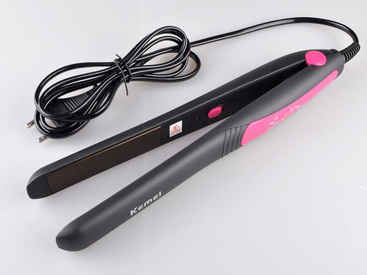 Black and pink hair straightener with cord on a white background