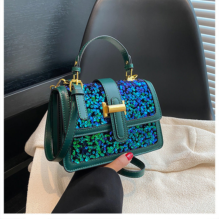 Teal blue sequined shoulder bag with flap, gold buckle, and matching short handles