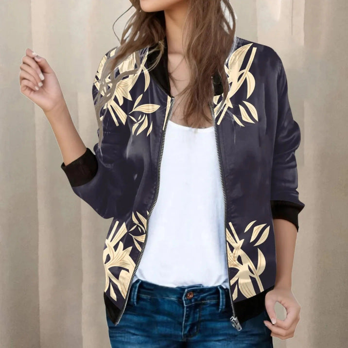 Navy bomber jacket with gold leaf patterns worn by a person against a neutral background