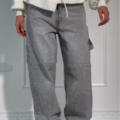 Person wearing gray pants with a subtle pattern against a neutral background