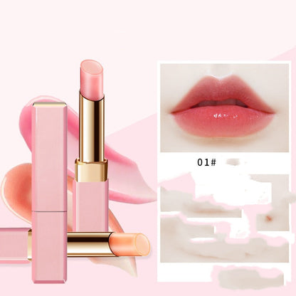 Pink lipstick with gold accents on a pink background, showing a close-up of lips wearing the shade.
