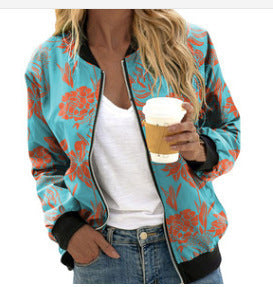Person wearing a colorful floral jacket holding a coffee cup.