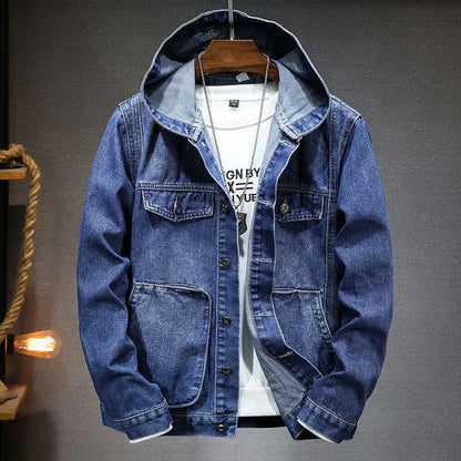 Blue denim jacket on a hanger against a gray background