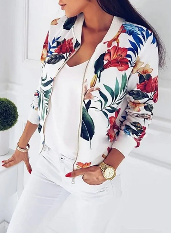 Person wearing a colorful floral bomber jacket over a white shirt.