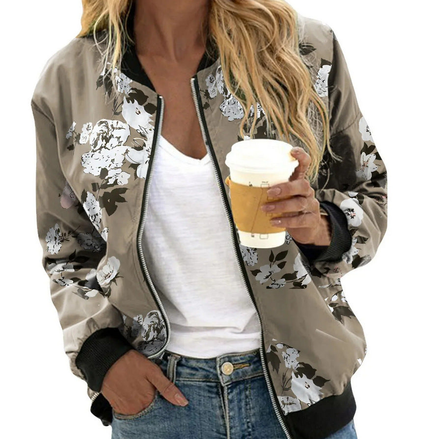 Woman wearing a floral bomber jacket holding a coffee cup on a white background