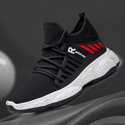 Black and white athletic shoe with red accents on a gray background